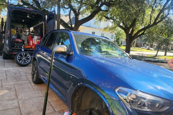 Mobile tire replacement on a BMW X5 performed by Houston Mobile Tire Service at a customer’s home in Houston.